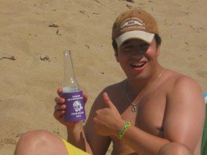 A boy with cap smiling enjoy his beach's coolie at coolienation.com
