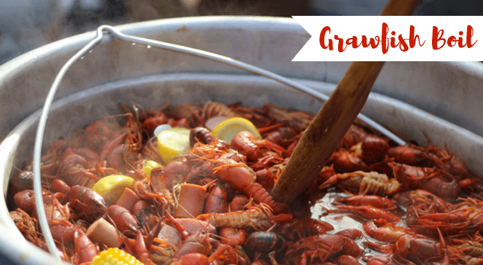 Boiling crawfish crockpot with lemon, corn and sausages