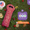 Red personalized wine bottle cooler for birthday with custom name and message, displayed on grass with fruit accents, by CoolieNation.