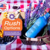 Blue personalized wine bottle cooler in picnic setting with grapes and flowers, featuring rush delivery options from CoolieNation.