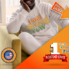 A man sitting on a couch wearing a white hoodie, showcasing personalized hoodies.