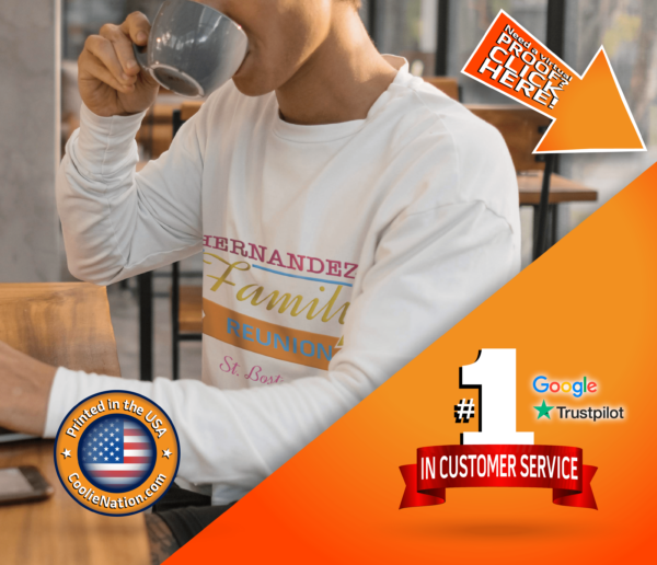 A man in a custom long sleeve shirt drinks coffee while attentively looking at his laptop custom apparel