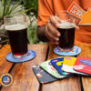 Custom coasters with a cold beer placed above them