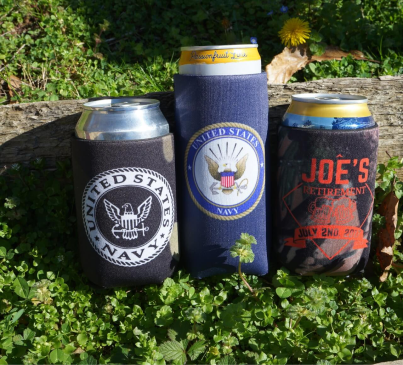 Three custom koozies with "Joe's Navy" written on them, designed to hold cans