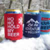 a group of custom can winter koozies in the snow