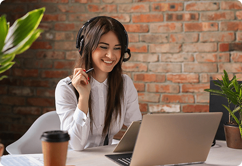 A woman on the phone, taking a rush order for custom koozies,