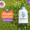 White custom hard foam koozie with real estate logo on grass, featuring rush delivery options from CoolieNation.